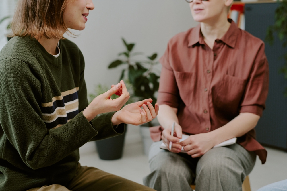 Person,Participating,In,Counseling,Session,Indoors,With,Therapist,Taking,Notes